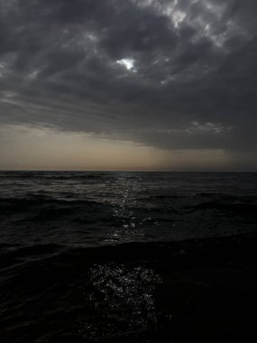 waves on the beach in Italy with dramatic sky. High quality photo