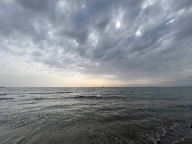waves on the beach in Italy with dramatic sky. High quality photo