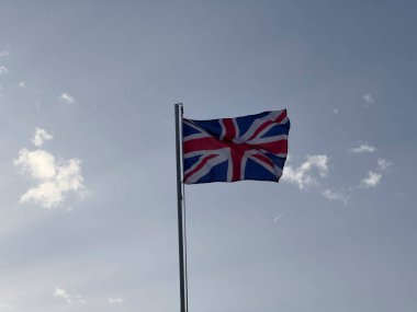 English flag waving in the wind on sunny day. High quality photo