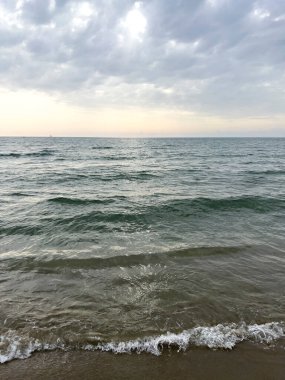 waves on the beach in Italy with dramatic sky. High quality photo