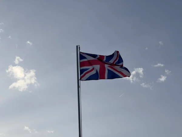 stock image English flag waving in the wind on sunny day. High quality photo