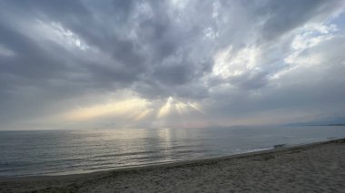waves on the beach in Italy with dramatic sky. High quality photo