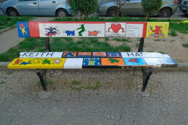 Turin, Italy - 2022 06 04: piazza Moncenisio Mau bench decorated with style of famous artists Keith Haring. High quality photo