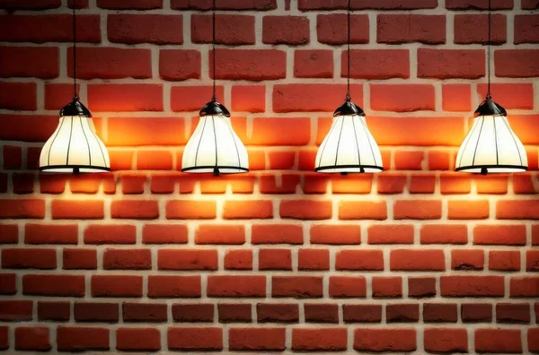 Many pendant lamps against red old brick wall. High quality photo