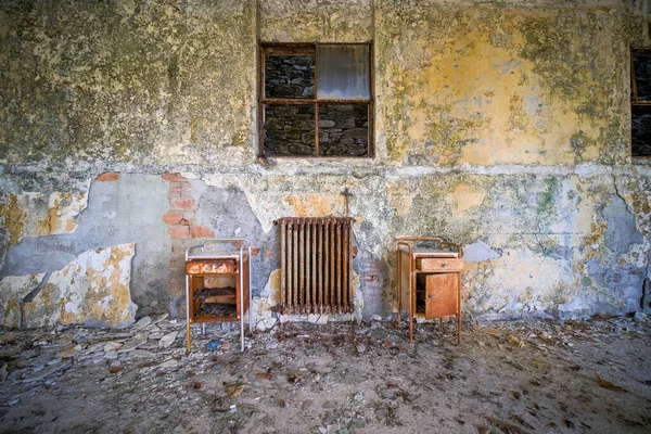 room with radiator and wallpaper in the abandoned house. High quality photo