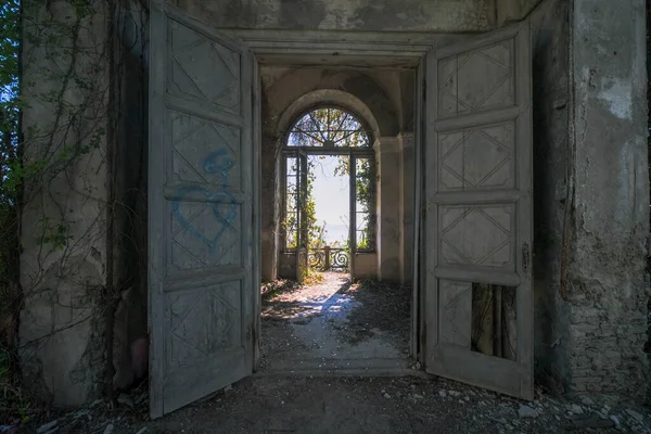 doors onto hall in large abandoned house in the abandoned house. High quality photo