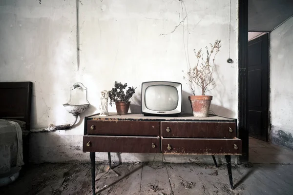 cabinet with small cathode ray tube television in the abandoned house. High quality photo