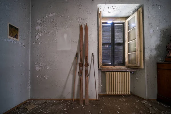 entrance with old wooden skis in abandoned house. High quality photo