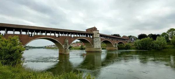 Stock image panorama covered bridge Pavia with the Ticino river. High quality photo