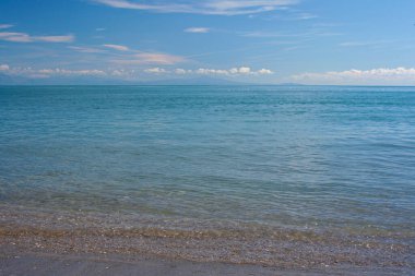 Amalfi Sahili 'nden sakin bir okyanus manzarası, sakin mavi suları, uzak kuşları ve soluk dağları, huzurlu kıyı manzarasını yakalıyor. Yüksek kalite fotoğraf