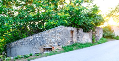 Kırık camları ve kapısı olan, İtalya 'da çürümeyi ve terk edilmeyi temsil eden yıkık bir binanın eski, yıkık taş ve tuğla duvarı. Yüksek kalite fotoğraf