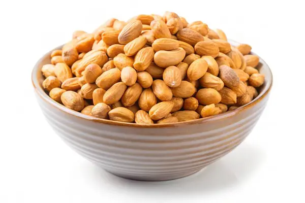 stock image Roasted peanuts in a bowl isolated on white background