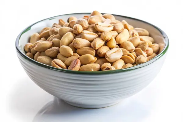 stock image Roasted peanuts in a bowl isolated on white background