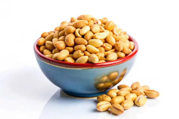 stock image Roasted peanuts in a bowl isolated on white background