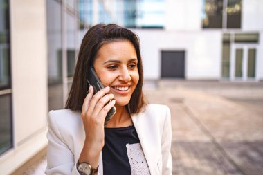 İş kadını işten sonra telefonda konuşuyor..