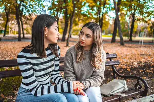 Two Women Sitting Park Bench Facing Each Other Looking Each — Stock Photo, Image