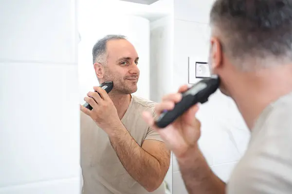 Man Shaves His Beard Trimmer Bathroom — Stock Photo, Image