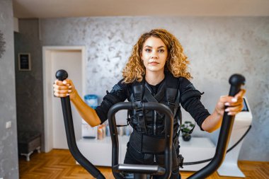 A person participates in an advanced fitness session in a modern gym. clipart