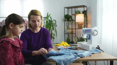 Bir anne kızına evde kot dikmeyi öğretir..