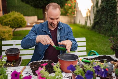 Erkekler bahçeye çiçek dikerken saksı dikerler..
