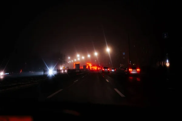 Mystic light of the night city on the highway. View from the car. The effect of soft focus, sleep. High quality photo