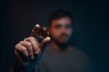 Man holding bitcoin. Financial ecosystem. The currency of the future. High quality photo
