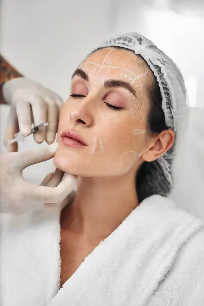 stock image Professional applies skin treatment to a clients face in a spa.