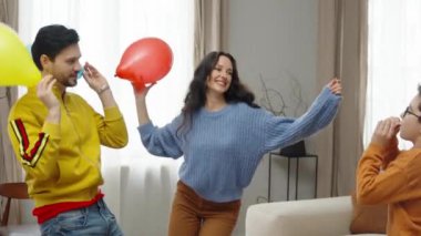 Neşeli bir ev kutlamasında bir grup arkadaş kahkaha ve eğlenceyi paylaşır.