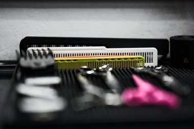 Various hairstyling tools are neatly organized on a work surface at a salon. clipart