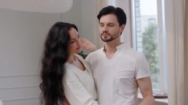 Güneşli oturma odalarında neşeyle dans eden bir çift..