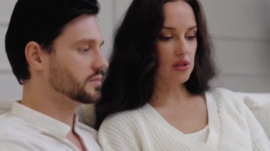 İki insan evde dinlenirken düşünceli bir anı paylaşıyor..