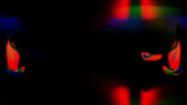 Koyu bir arkaplan karşısında renkli desenler ortaya çıkar.