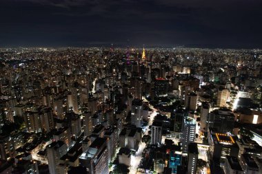 Parlak şehir ışıkları gece genişleyen şehir manzarasının üzerinde parlıyor..