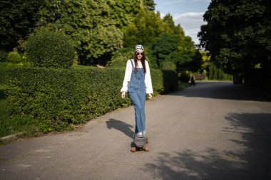 Kaykaycı verimli yeşilliklerle çevrili sakin bir yolda süzülüyor.