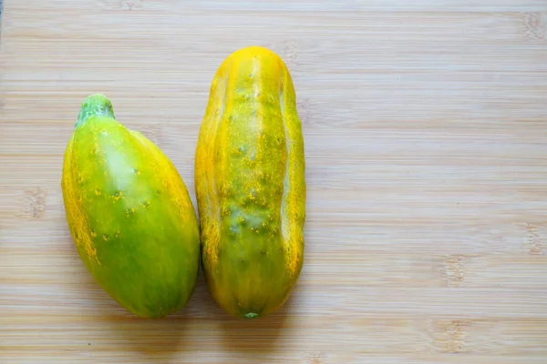 Yellow Big Cucumbers Wooden Cutting Plate — Stock Photo, Image