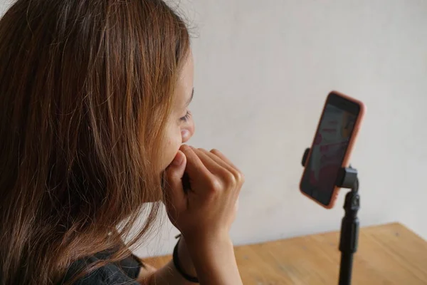 stock image Latin hispanic teenage Guatemalan girl enjoying video call on phone with her family