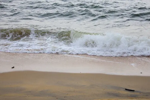 stock image A serene capture of gentle waves washing up on the sandy shores.