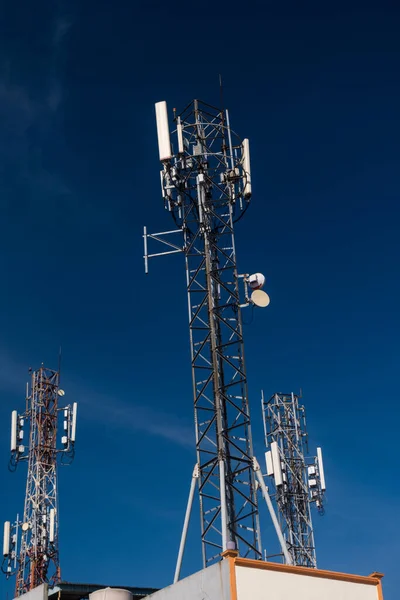 Telecommunication tower of 4G and 5G cellular. Base Station or Base Transceiver Station. Wireless Communication Antenna Transmitter. Telecommunication tower with antennas against blue sky background
