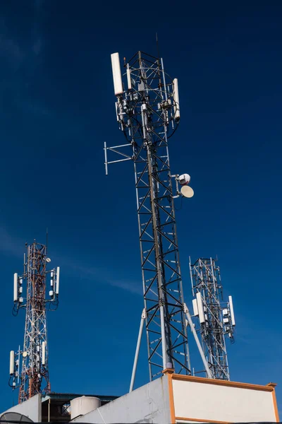 Telecommunication tower of 4G and 5G cellular. Base Station or Base Transceiver Station. Wireless Communication Antenna Transmitter. Telecommunication tower with antennas against blue sky background