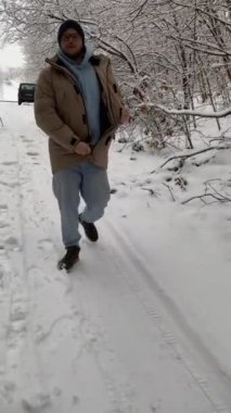 Mutlu kadın çay içiyor ve selfie çekiyor. Çiftler kış mevsiminde karlı ormanda buluşuyorlar.