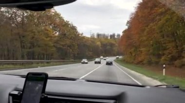 driving car by autumn highway road trip