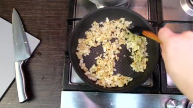 frying onions on the pan domestic kitchen stove overhead view