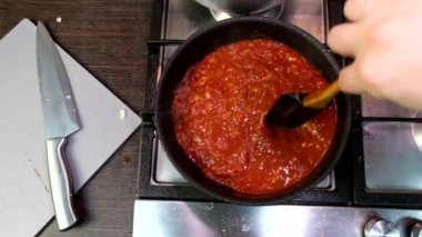 cooking at domestic kitchen overhead view red tomatoes sauce on frying pan healthy food