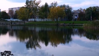 autumn evening city park with lake at autumn day panoramic view