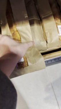 Pov kadın eli market kabuğundan ekmek alır.