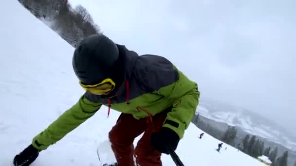 スノーボーダーマン スノーボーダー スロープヒルでダウンしながらセルフィーを取る — ストック動画