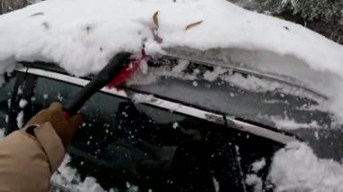 kişi perspektifi adam kar fırtınasından sonra araba temizleme