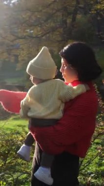 Mother and Baby in Autumn Park Sunlight