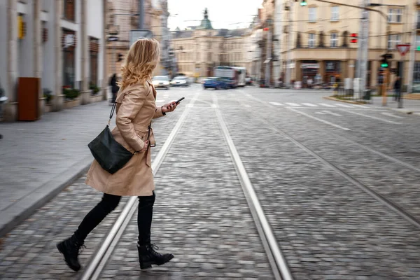 stock image Late again to work. Panning shot of rushing woman crossing street. City life. Blurred motion