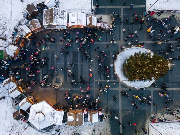 overhead view of city center at christmas holidays overcrowded square with street food